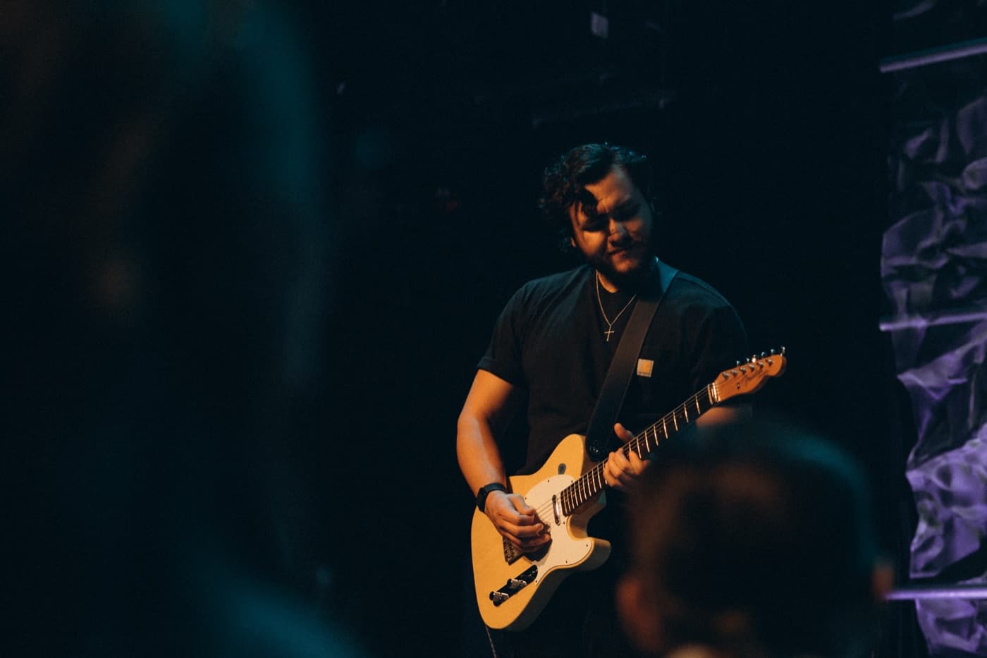 Alex Gonzalez, founder of SetBook, playing guitar on stage